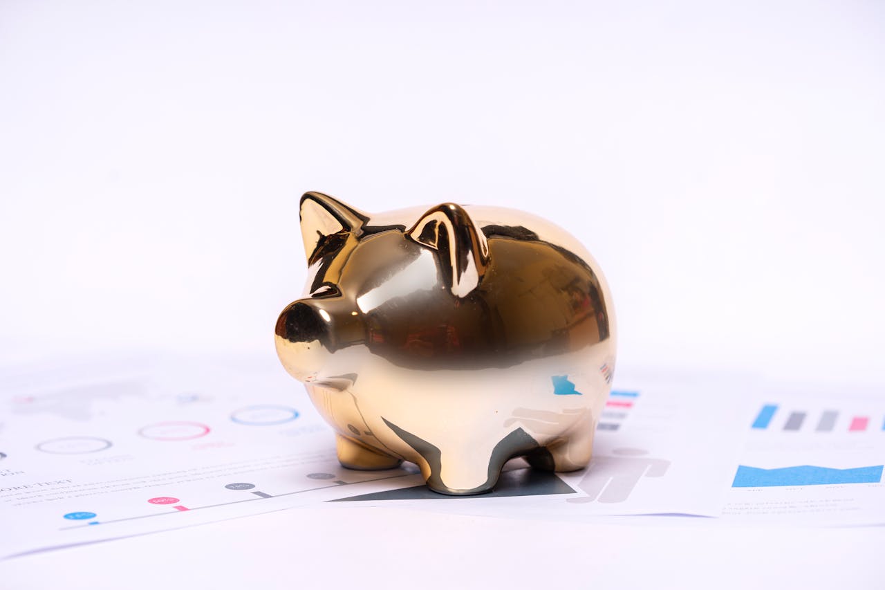 Crafting Captivating Headlines: Your awesome post title goes here Close-up of a golden piggy bank on financial documents, symbolizing savings and investment.