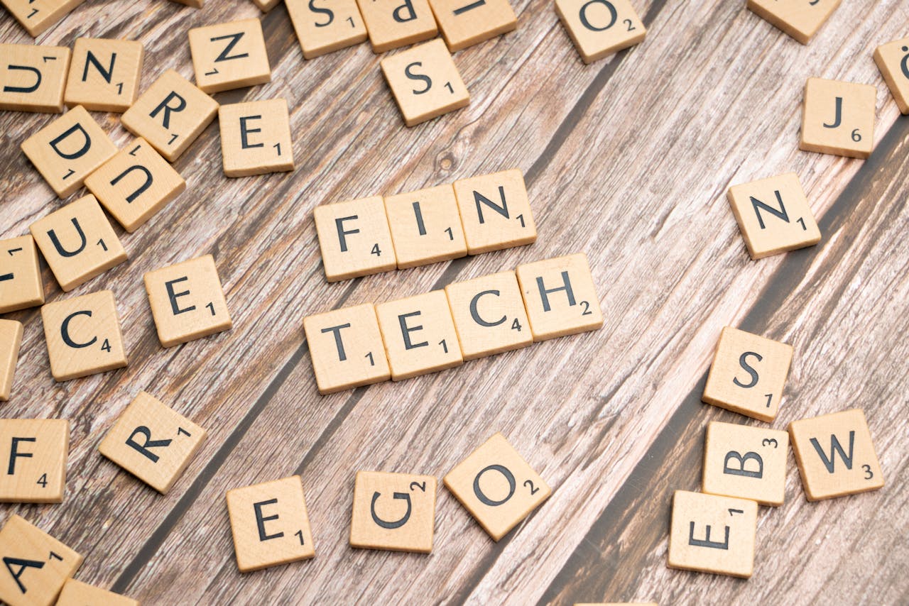 Mastering the First Impression: Your intriguing post title goes here Fintech spelled out with wooden letter tiles on a rustic wooden background.